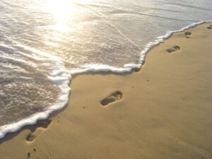footprints-man-beach-morning